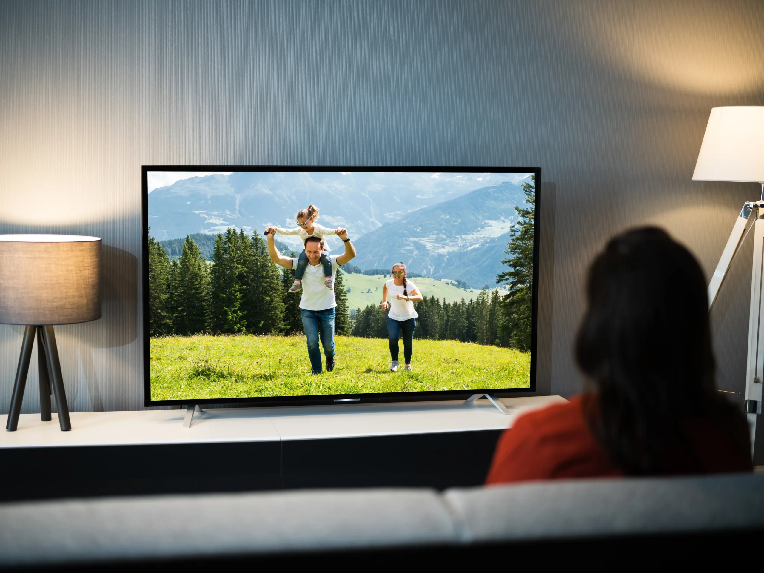 5 Advantages of TV Advertising - Woman watching advertisement on TV